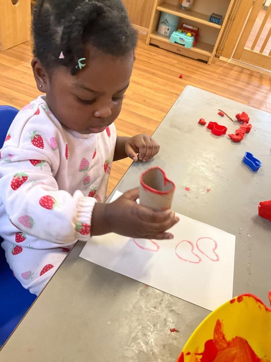 a destiny haven nursery child engages in a creative stamping activity