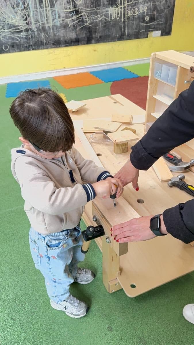 destiny haven nursery child working on a wooden construction project