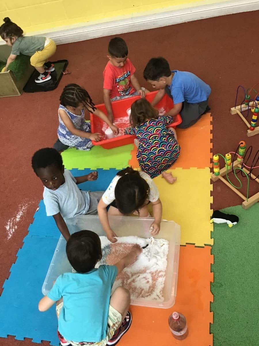 destiny haven nursery children engage in sensory play with sand and water