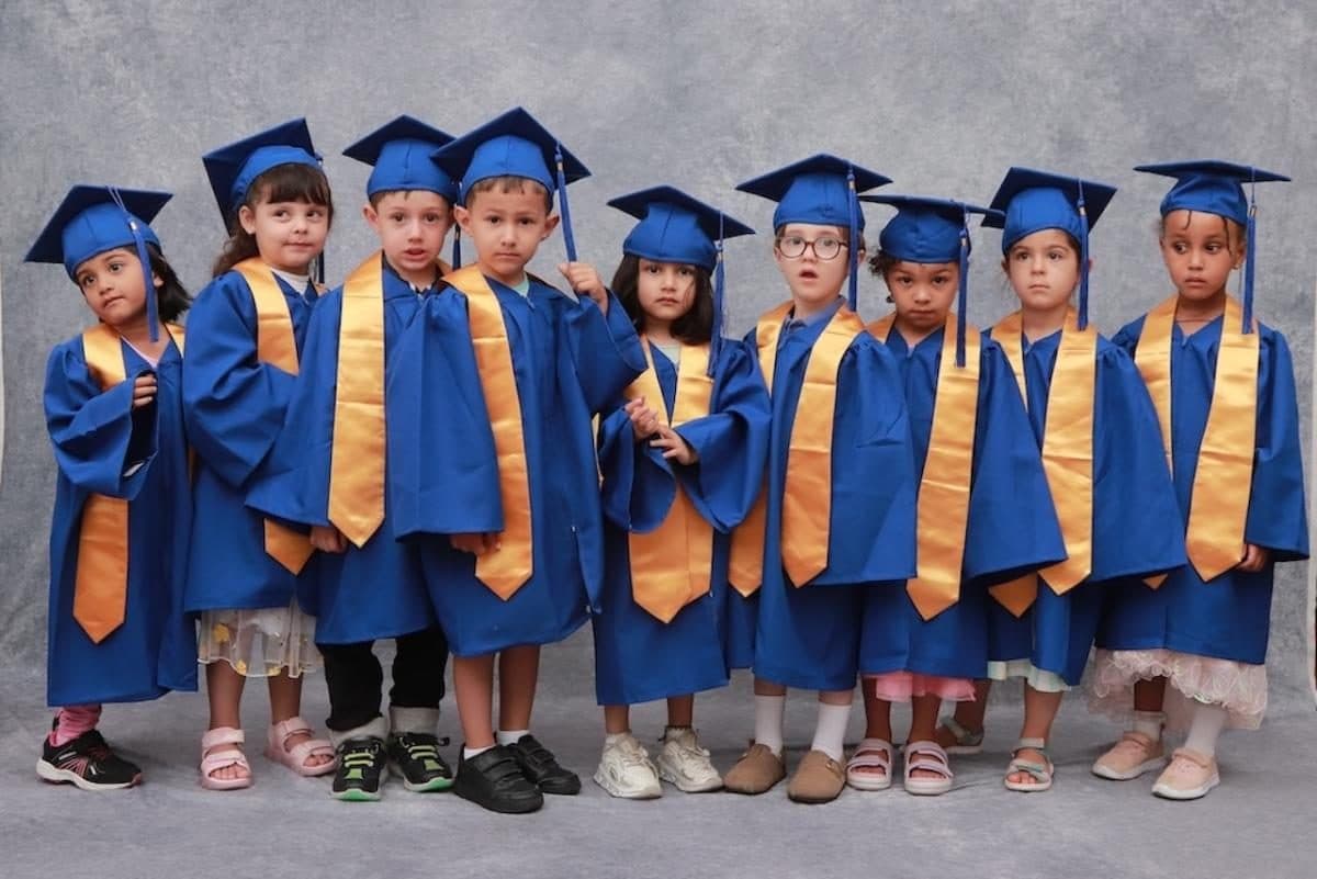 destiny haven nursery graduates in blue robes and gold sashes