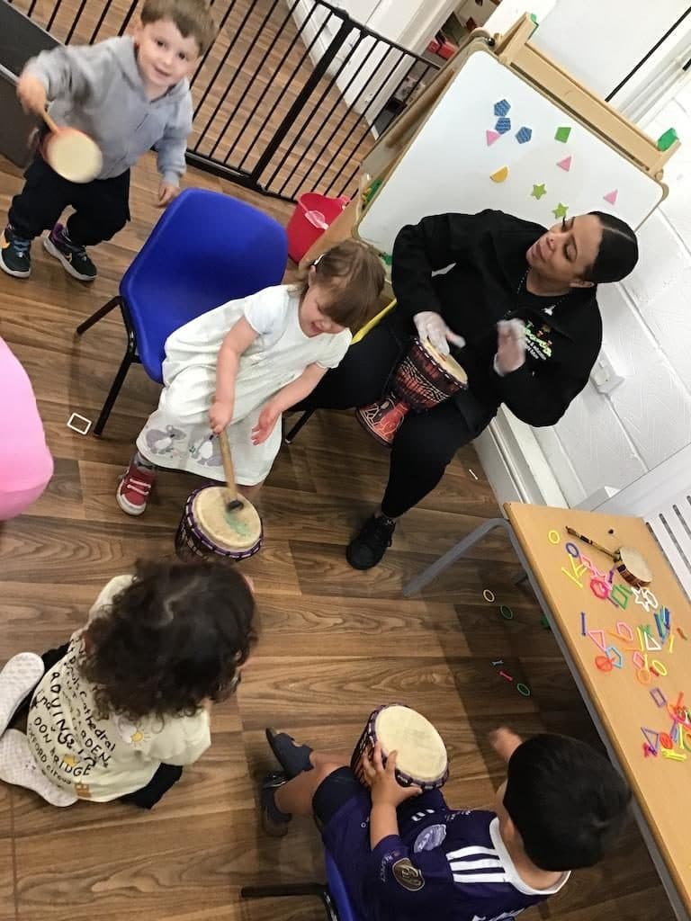 destiny haven nursery music class with children playing hand drums