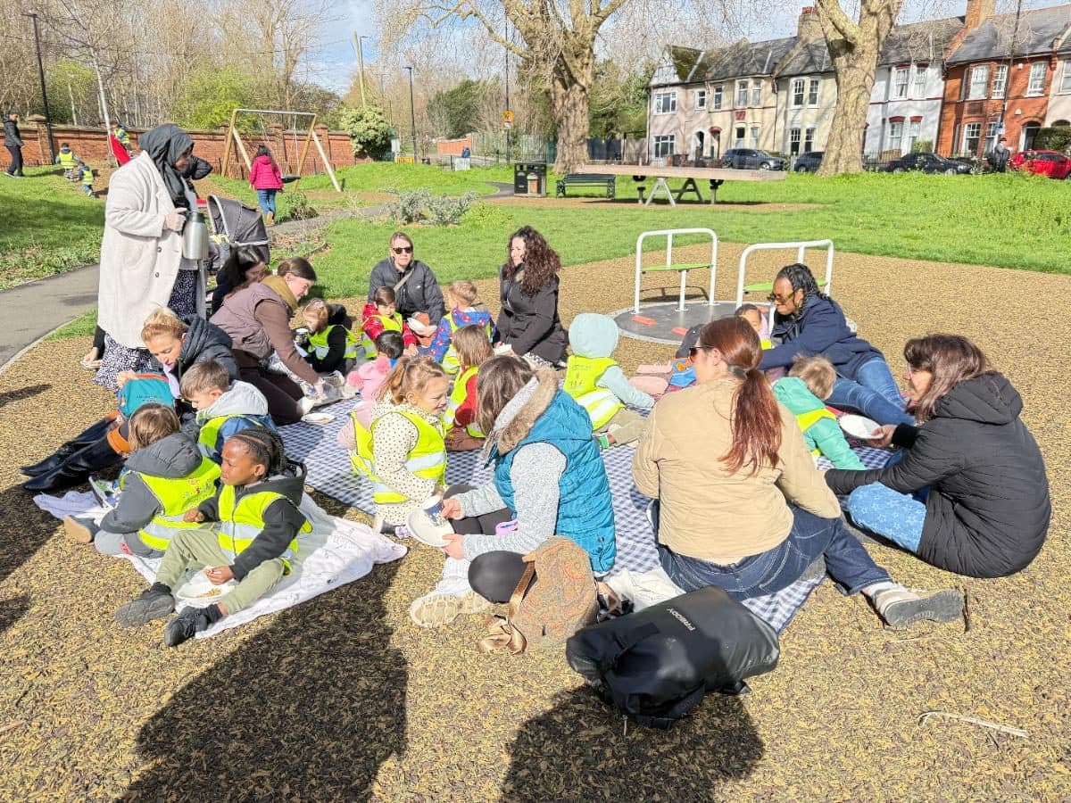 destiny haven nursery outdoor gathering on park ground with children seated