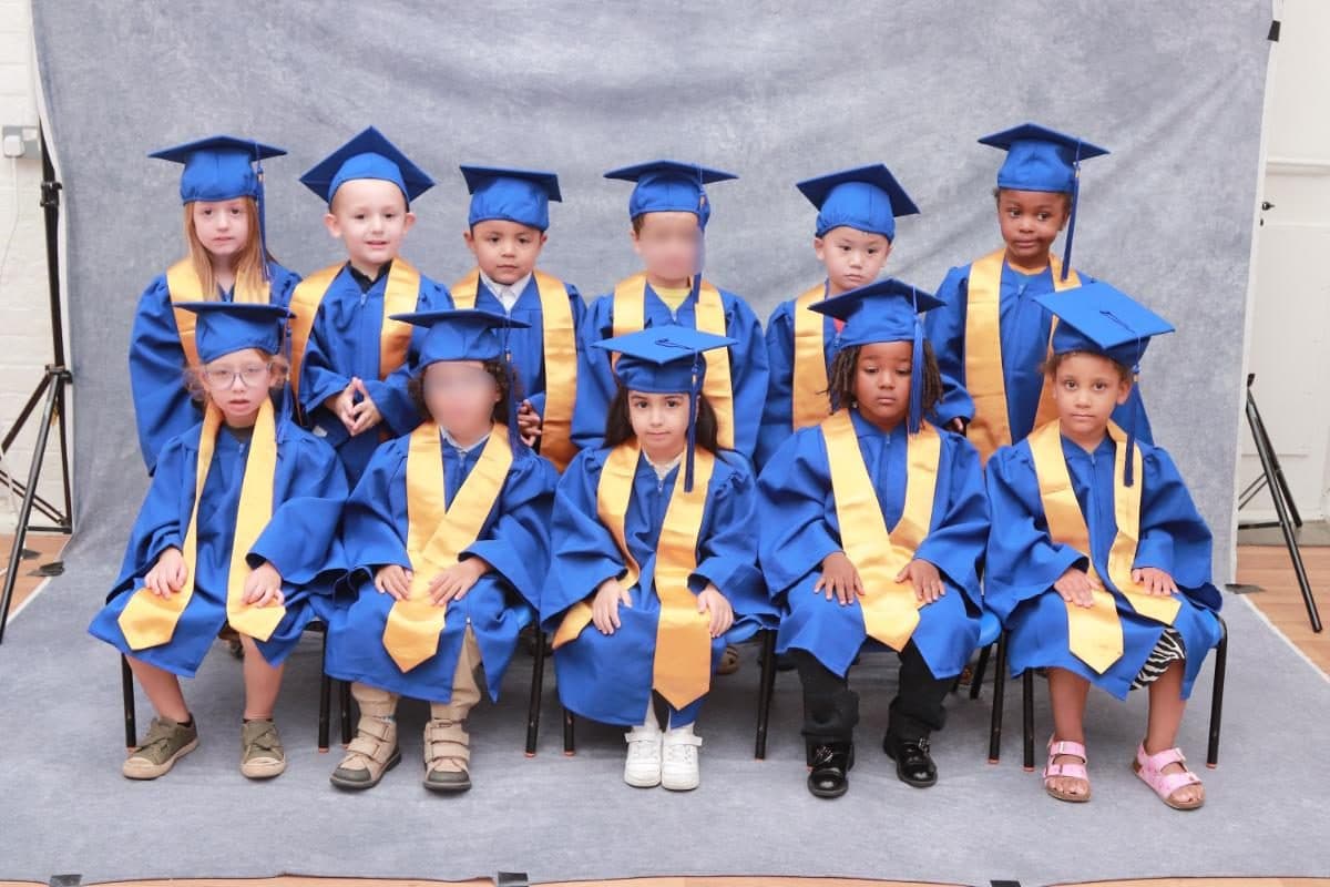 destiny haven nursery nursery children pose together in graduation caps and gown