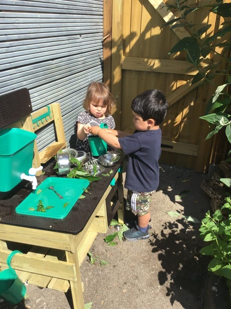 two children explore nature at destiny haven nursery in noel park